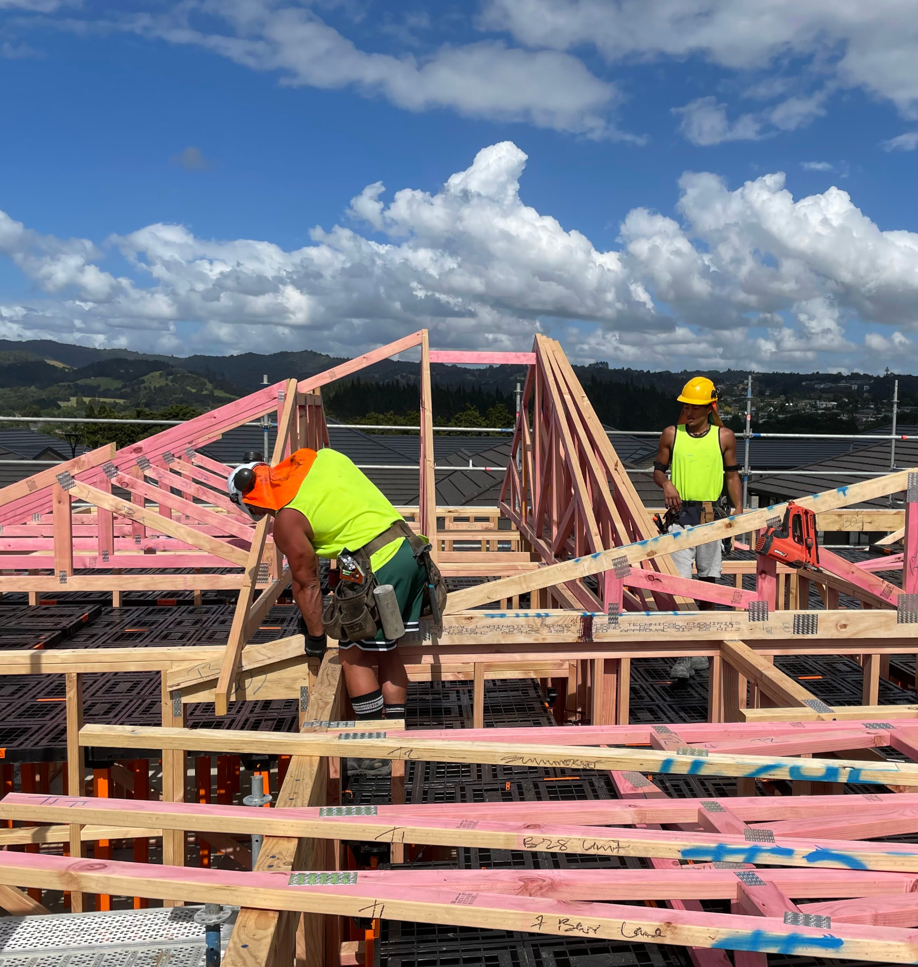 Builders fixing timber trusses above a Workdek platform on a retirement village site