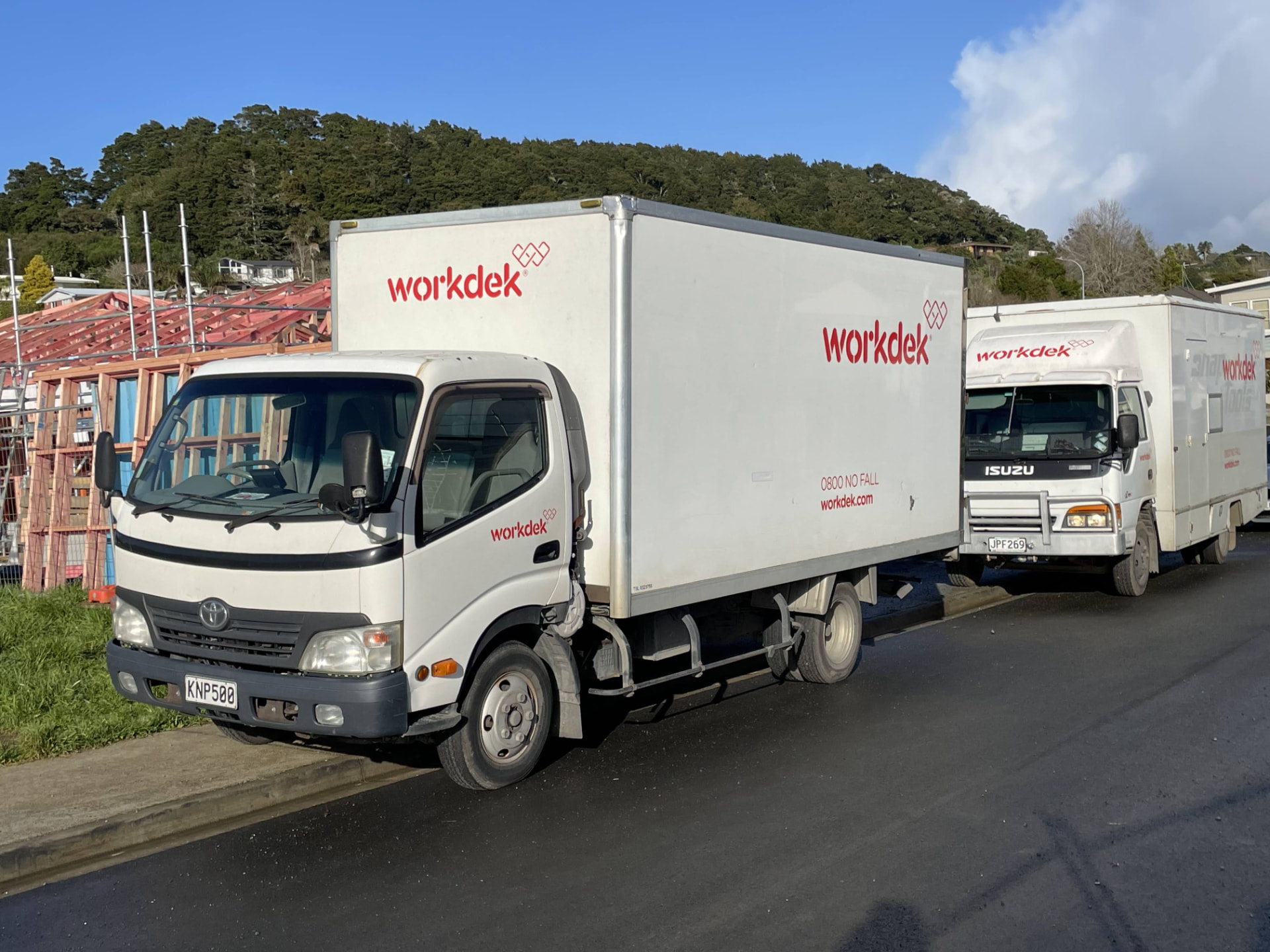 Workdek delivery truck parked at the kerb beside a house under construction